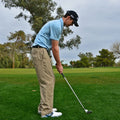 Golfer lining up a shot.